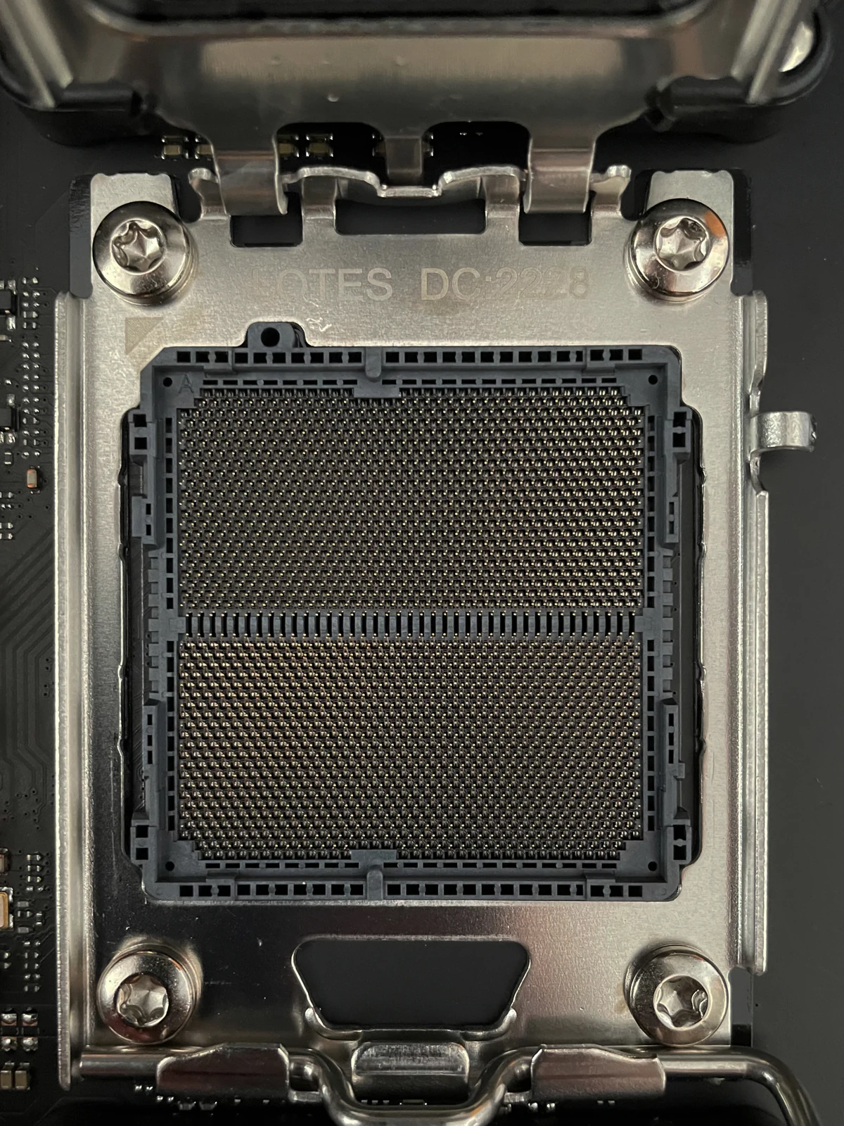 An AM5 socket with its retention frame open and its contacts exposed