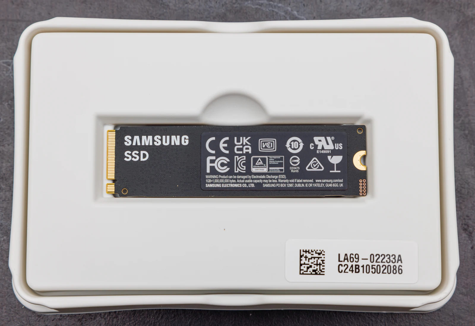 A Samsung 990 PRO M.2 NVMe SSD with its gold edge connector and mounting end visible