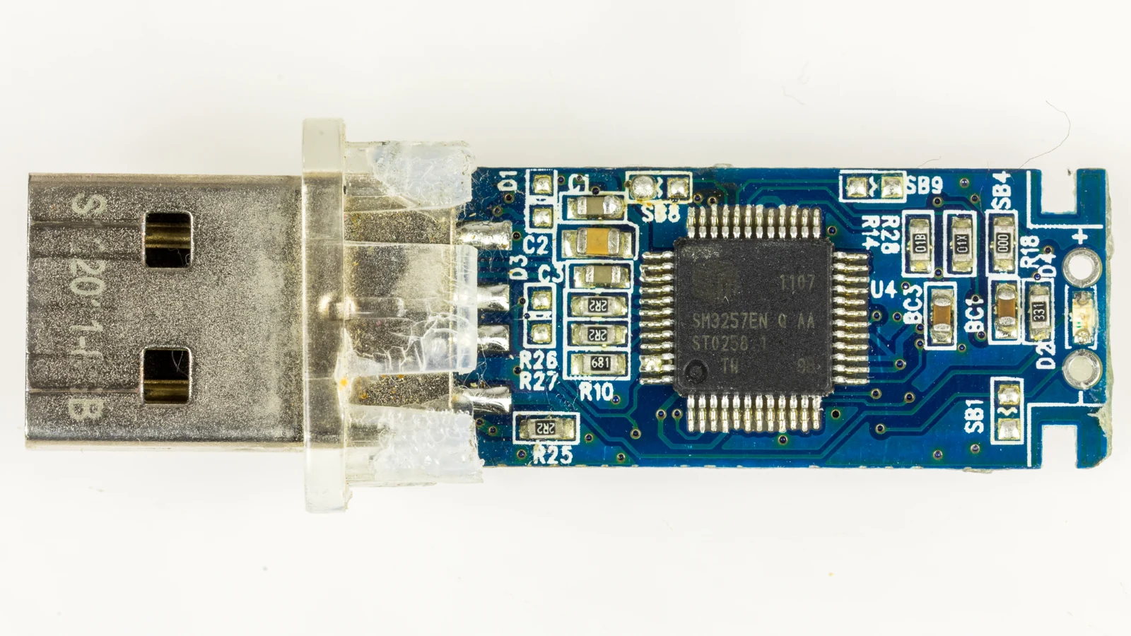 Real macro photograph of a USB flash drive with its internal circuit board visible.